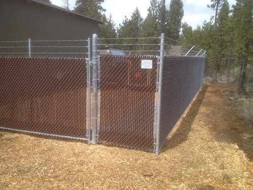 Chain link fence with barb wire along time