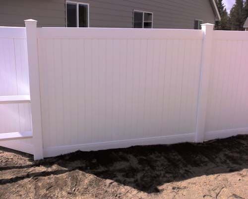 Vinyl privacy fence in front of house