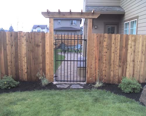 Cedar fence and arbor over metal gate